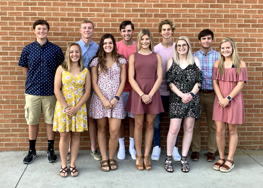 boys and girl along a brick wall